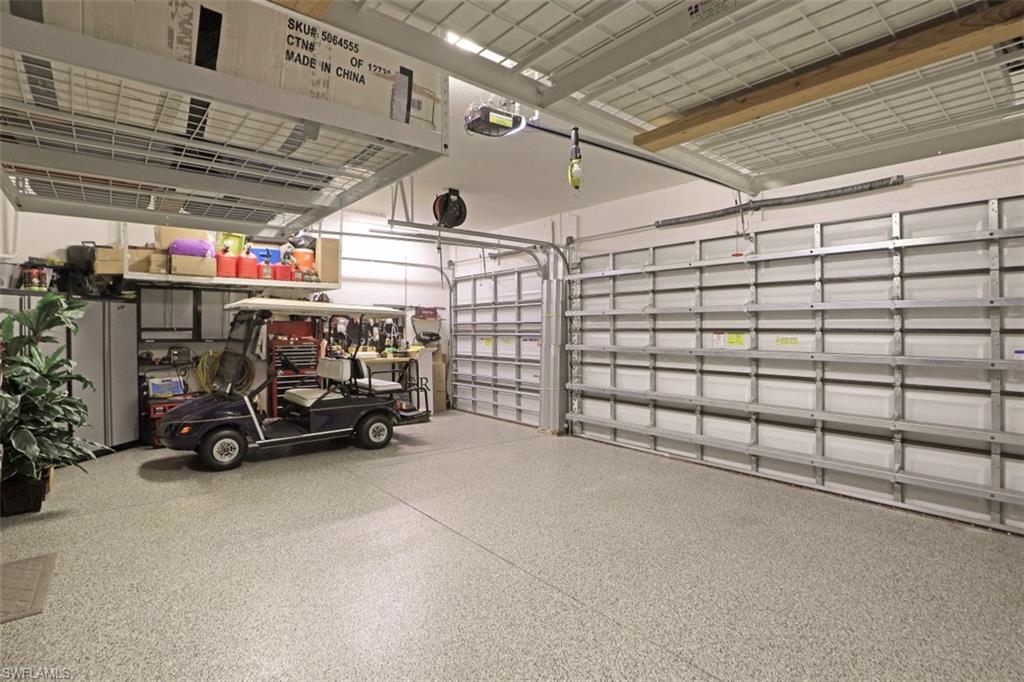 2832 Cinnamon Bay Circle Naples, FL 34119 - Photo 30 of 35 a view of parking garage with cars