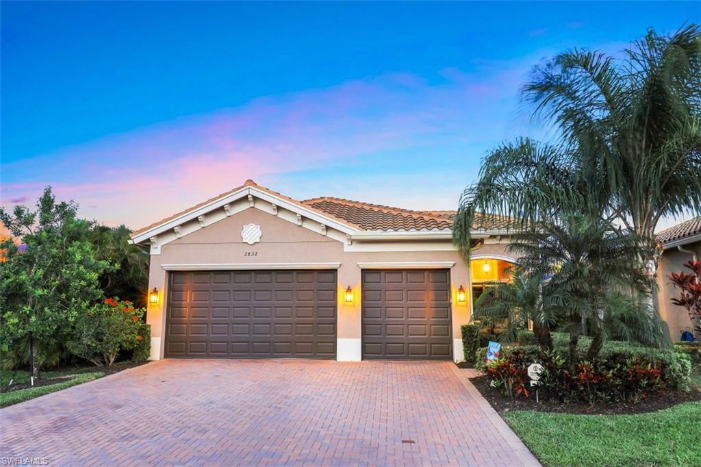 2832 Cinnamon Bay Circle Naples, FL 34119 - Photo 34 of 35 a front view of a house with a yard and garage