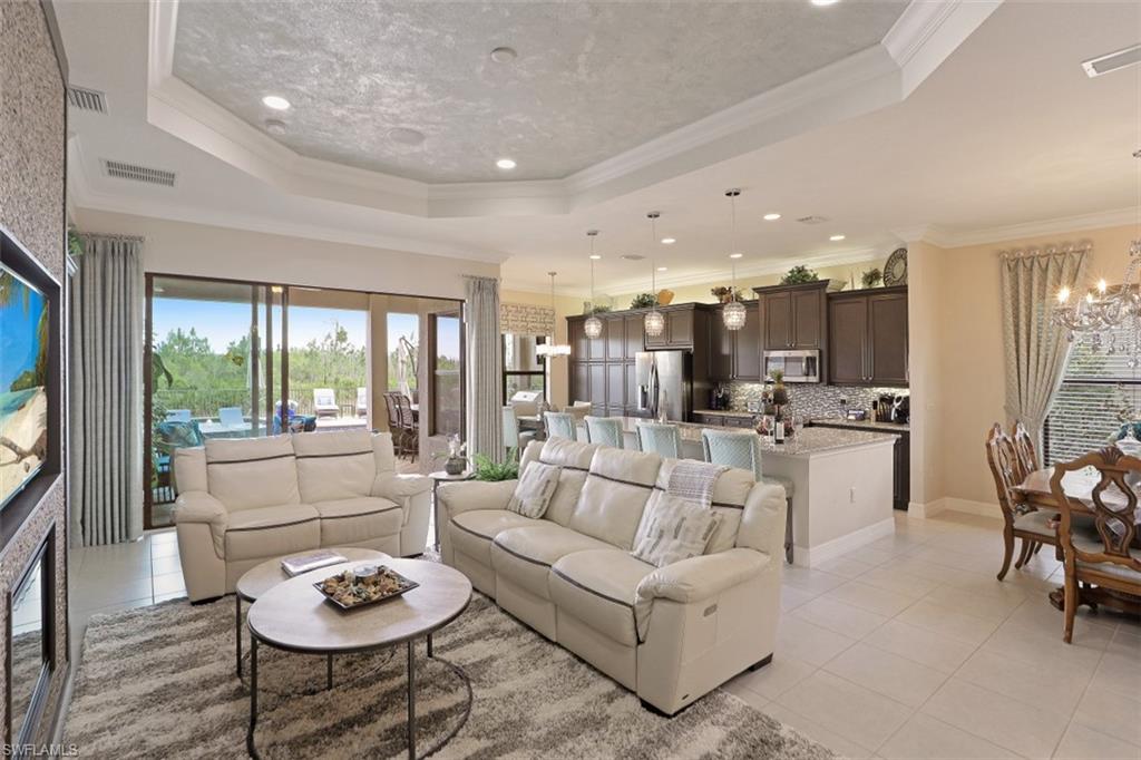 2832 Cinnamon Bay Circle Naples, FL 34119 - Photo 6 of 35 a living room with furniture and a large window