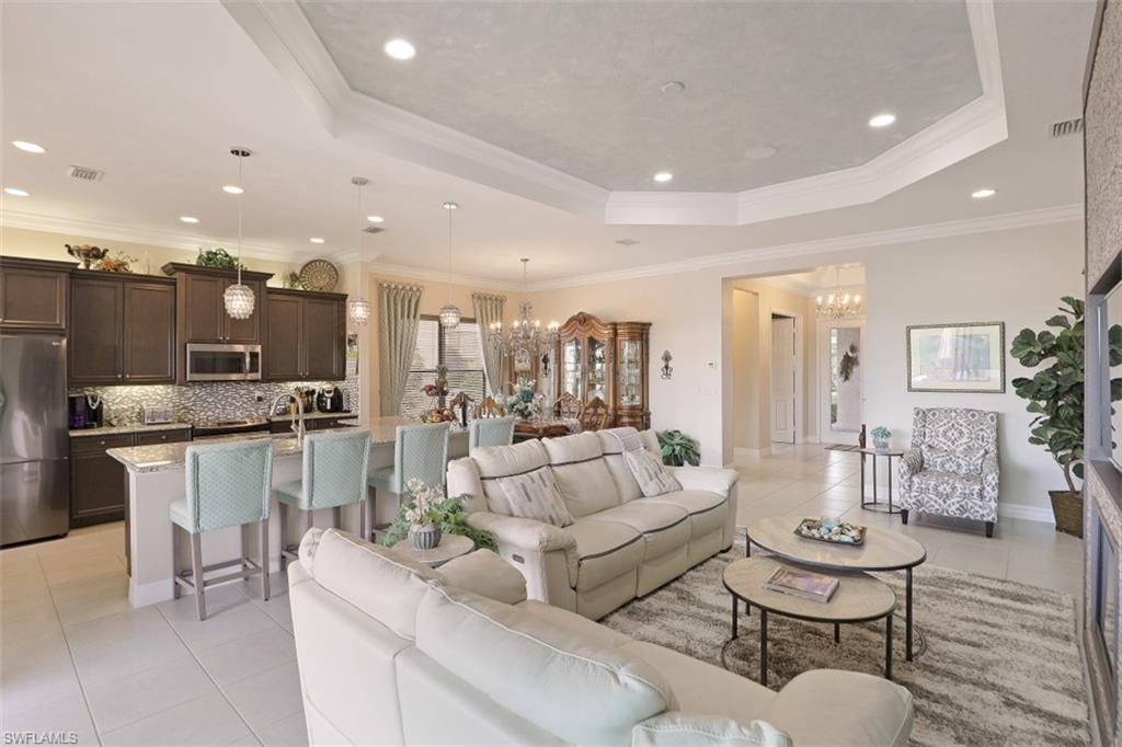 2832 Cinnamon Bay Circle Naples, FL 34119 - Photo 7 of 35 a living room with furniture and kitchen view