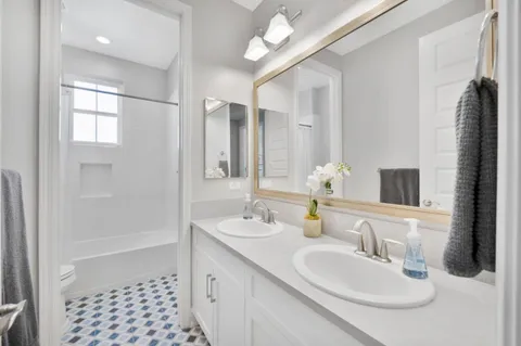 a bathroom with a sink a mirror and a shower