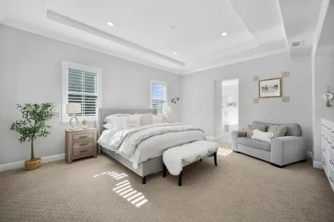 a spacious bedroom with a bed and a couch