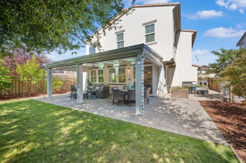 a view of a house with backyard porch and sitting area
