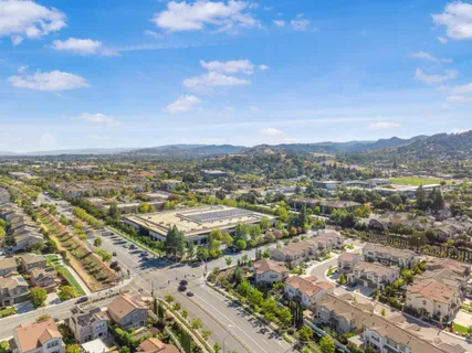 an aerial view of residential building with green space