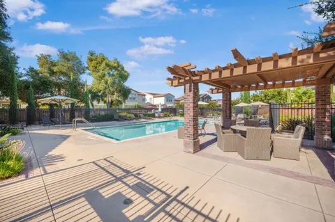 a view of a patio with dining table and chairs with wooden floor