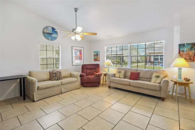 a living room with furniture a chandelier and a window