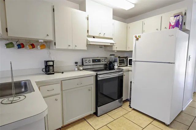a white refrigerator freezer sitting in a kitchen