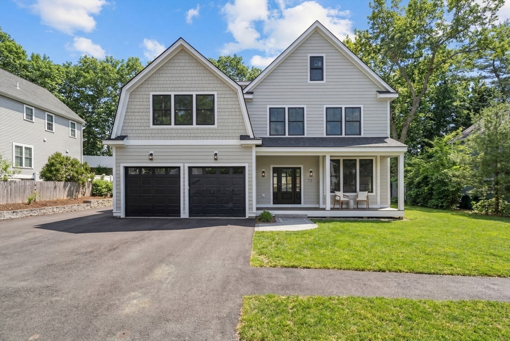 72 Valley Road Needham, MA 02492 - Photo 38 of 42 a front view of a house with a yard and garage