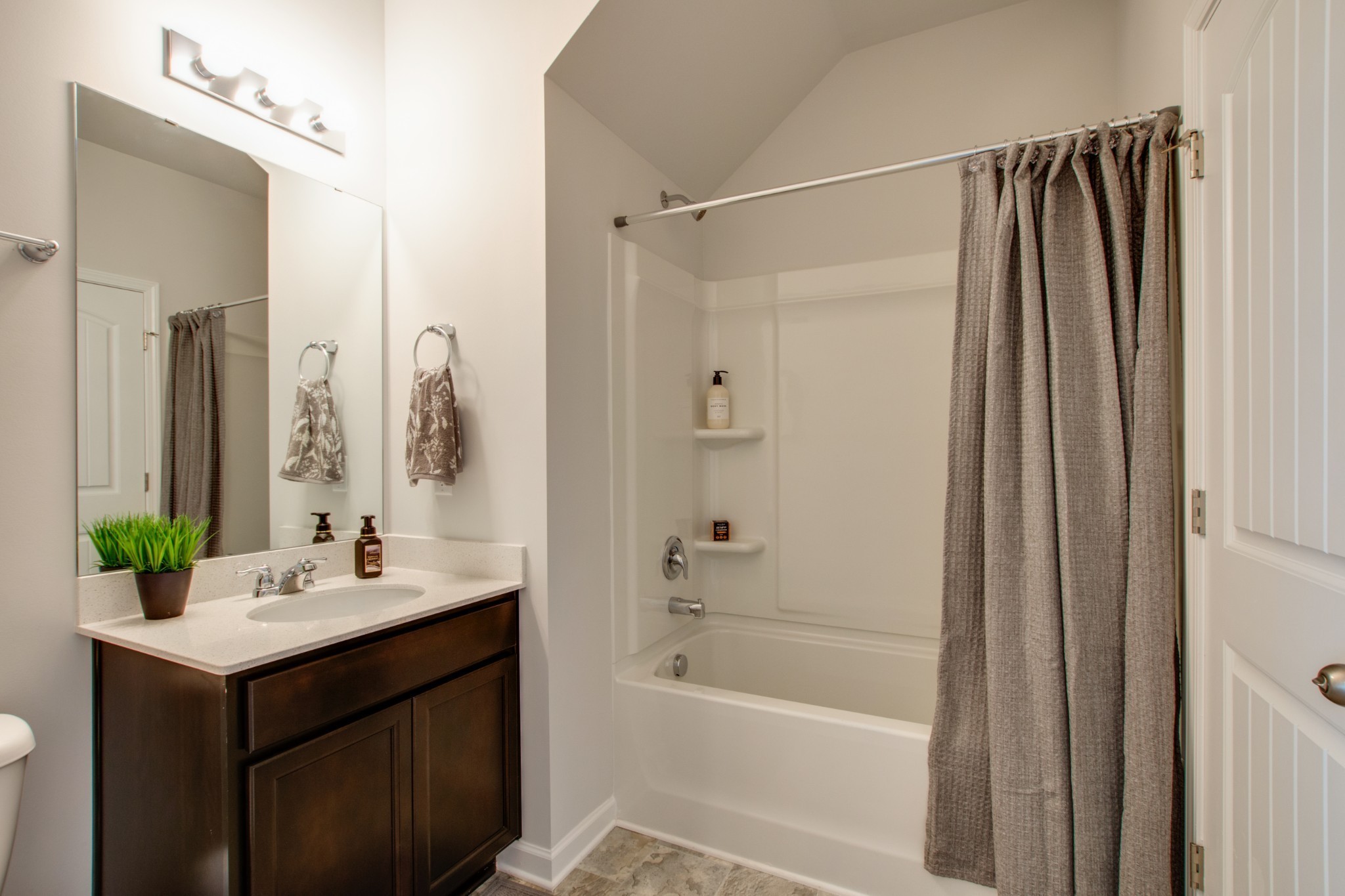 411 Waterfowl Way, Unit 119 Lebanon, TN 37090 - Photo 19 of 32 a bathroom with a bathtub sink vanity and mirror