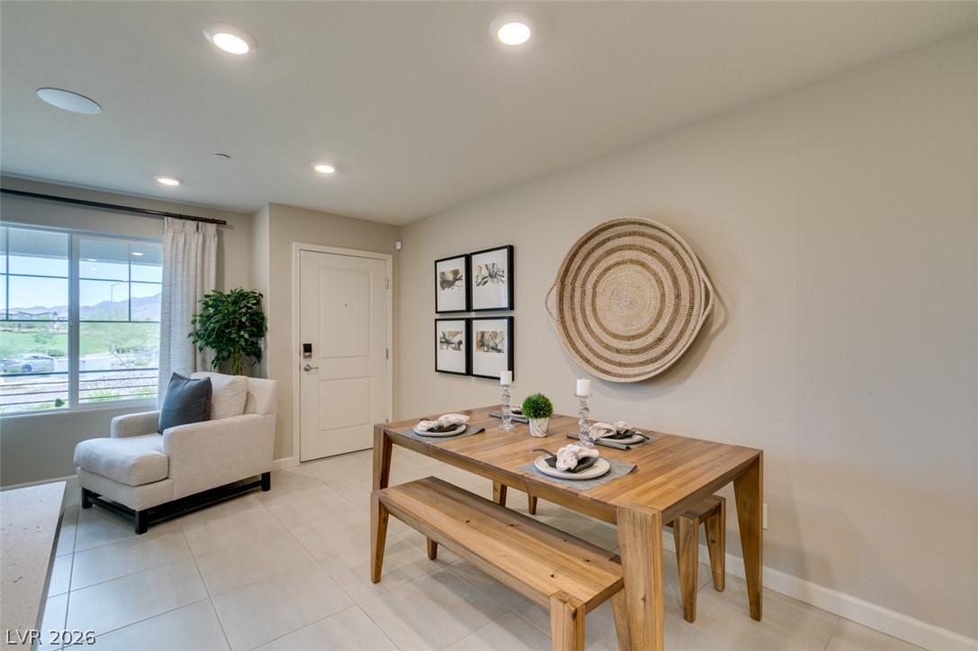 653 Pickled Pepper Place Henderson, NV 89011 - Photo 33 of 35 Recessed lighting illuminates this dining space with an open floorplan, featuring tile flooring.