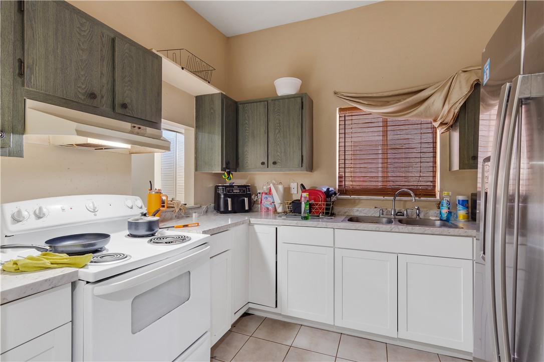422 Del Monte Road Sebastian, FL 32958 - Photo 14 of 35 a kitchen with sink cabinets and appliances