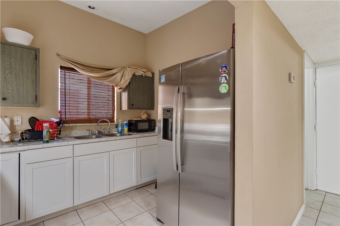 422 Del Monte Road Sebastian, FL 32958 - Photo 15 of 35 a kitchen with white cabinets and white appliances