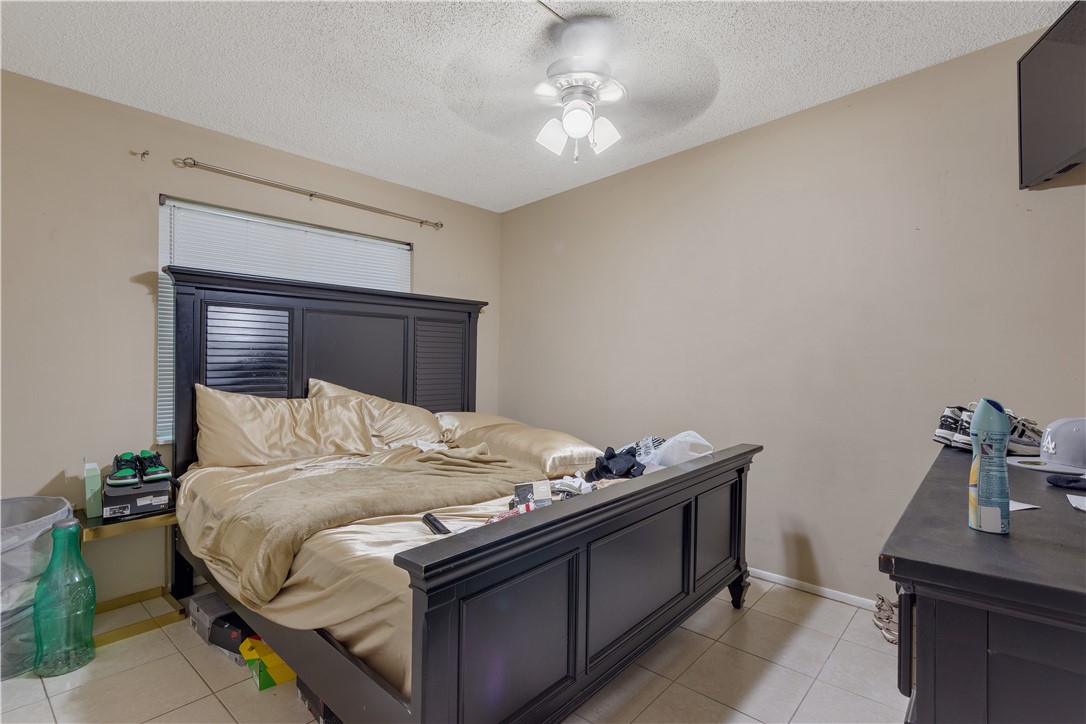 422 Del Monte Road Sebastian, FL 32958 - Photo 16 of 35 a bedroom with a bed and a table in it