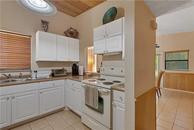 a kitchen with a sink stove and refrigerator