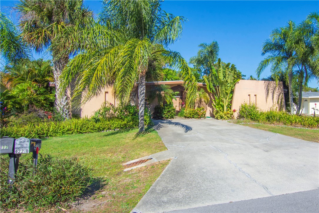 422 Del Monte Road Sebastian, FL 32958 - Photo 5 of 35 a backyard of a house with a garden and palm trees