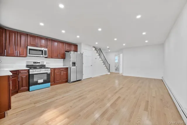 a kitchen with stainless steel appliances granite countertop a refrigerator sink and stove