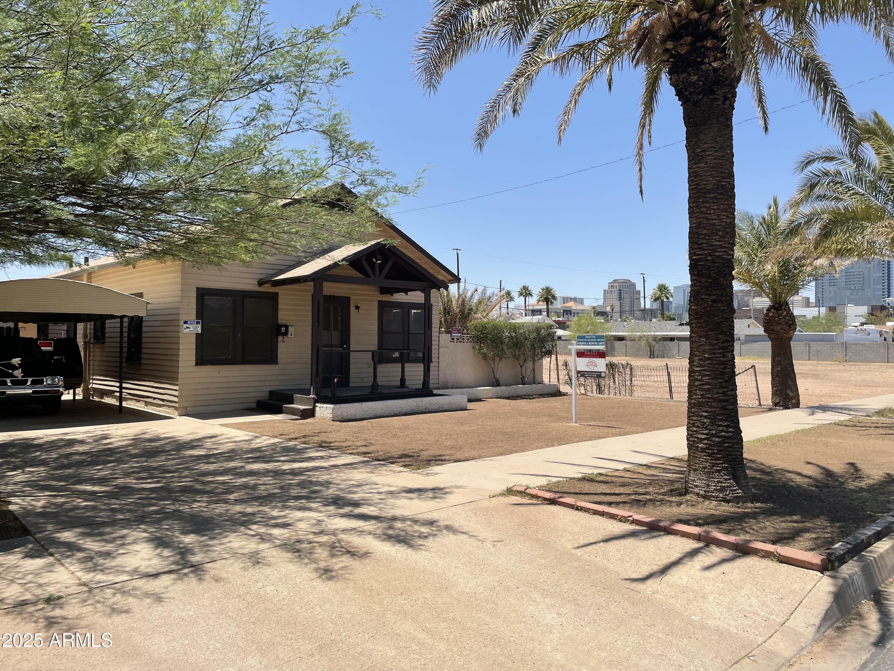 a front view of a house with a yard and trees