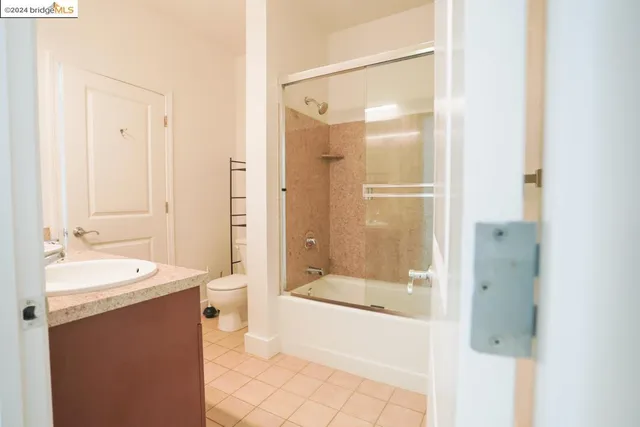a bathroom with a bathtub shower sink and mirror