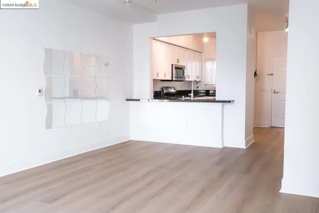 a kitchen with granite countertop a refrigerator and a sink