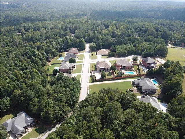a view of a large yard with lots of bushes