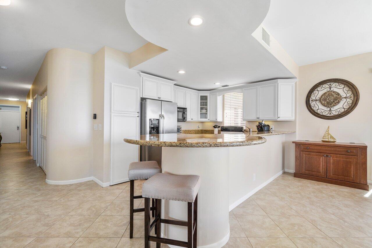 120 Inlet Way, Unit 204 Palm Beach Shores, FL 33404 - Photo 12 of 27 a large kitchen with a large counter top appliances and cabinets