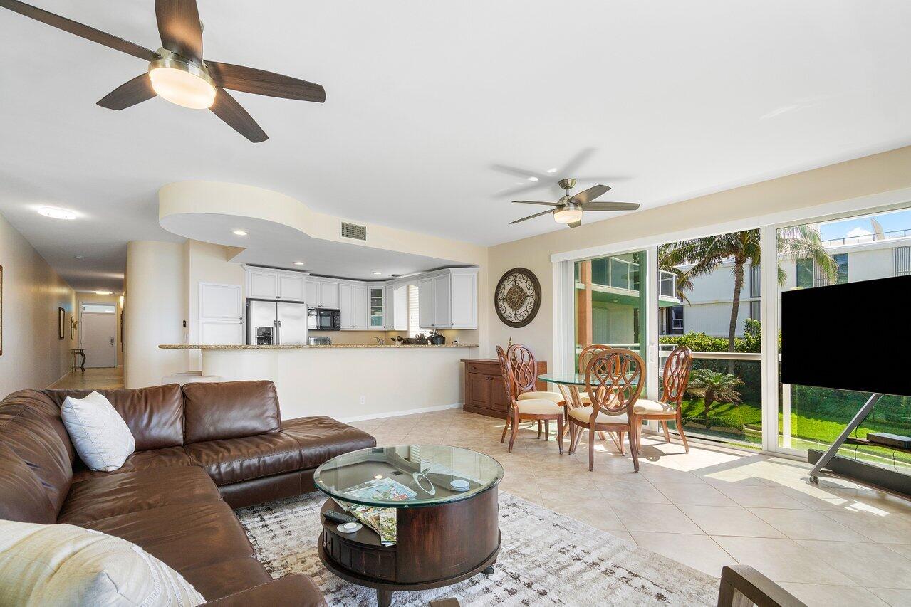 120 Inlet Way, Unit 204 Palm Beach Shores, FL 33404 - Photo 10 of 27 a living room with furniture and a flat screen tv