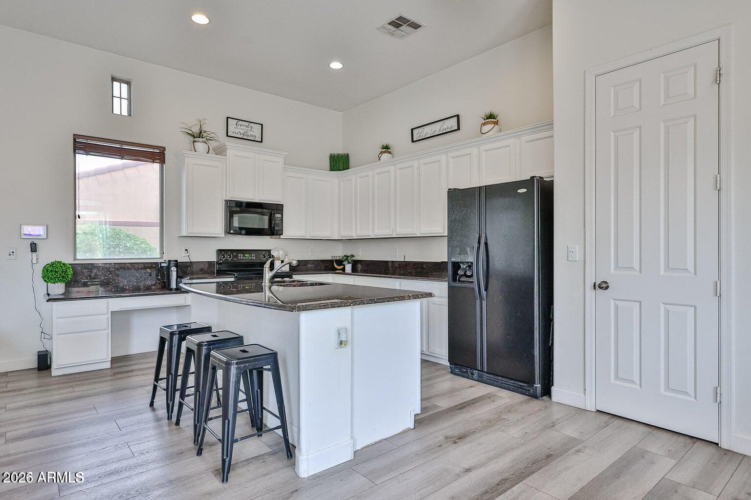 3950 North Edith Way Buckeye, AZ 85396 - Photo 8 of 32 a kitchen with granite countertop a refrigerator stove and sink