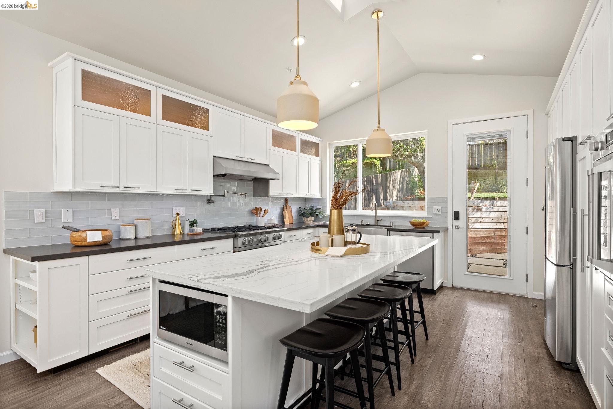 1471 Scenic Avenue Berkeley, CA 94708 - Photo 13 of 42 a kitchen with stainless steel appliances a stove a sink a refrigerator a center island and a stove