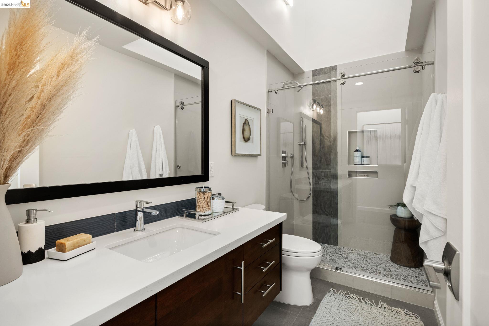 1471 Scenic Avenue Berkeley, CA 94708 - Photo 19 of 42 a bathroom with a sink a toilet a mirror and shower