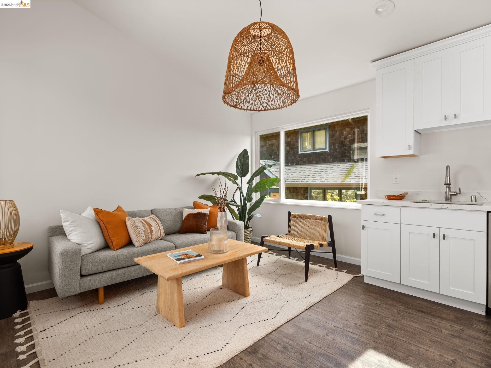 1471 Scenic Avenue Berkeley, CA 94708 - Photo 29 of 42 a living room with furniture a table and kitchen view