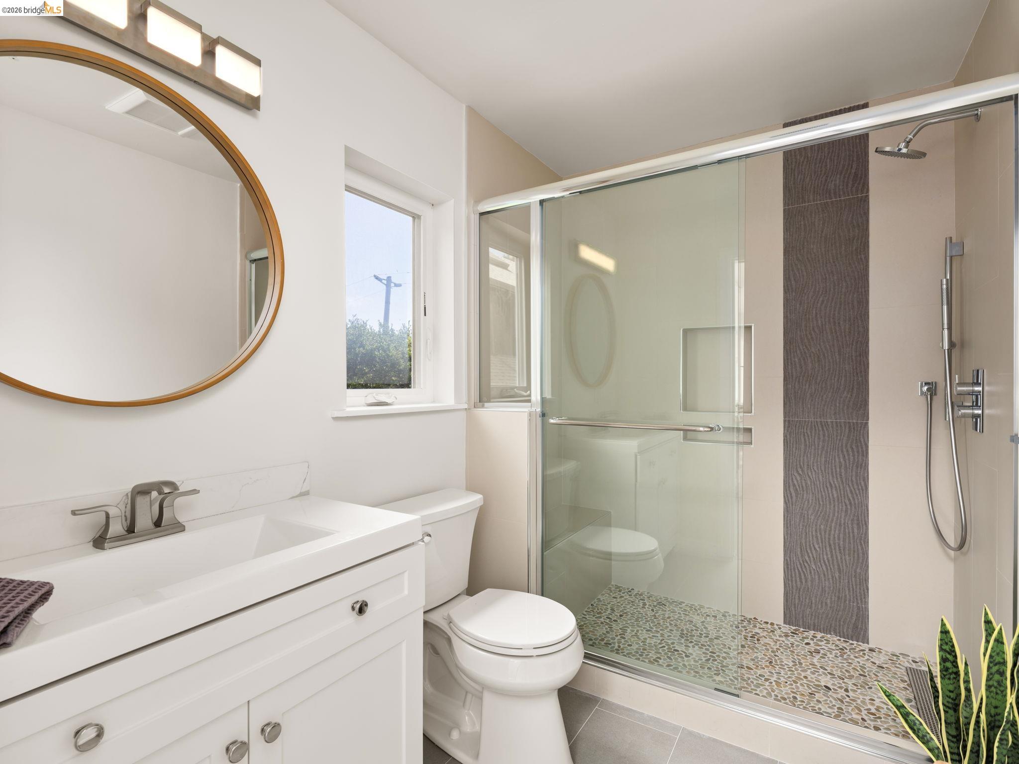1471 Scenic Avenue Berkeley, CA 94708 - Photo 34 of 42 a bathroom with a sink a toilet and a mirror