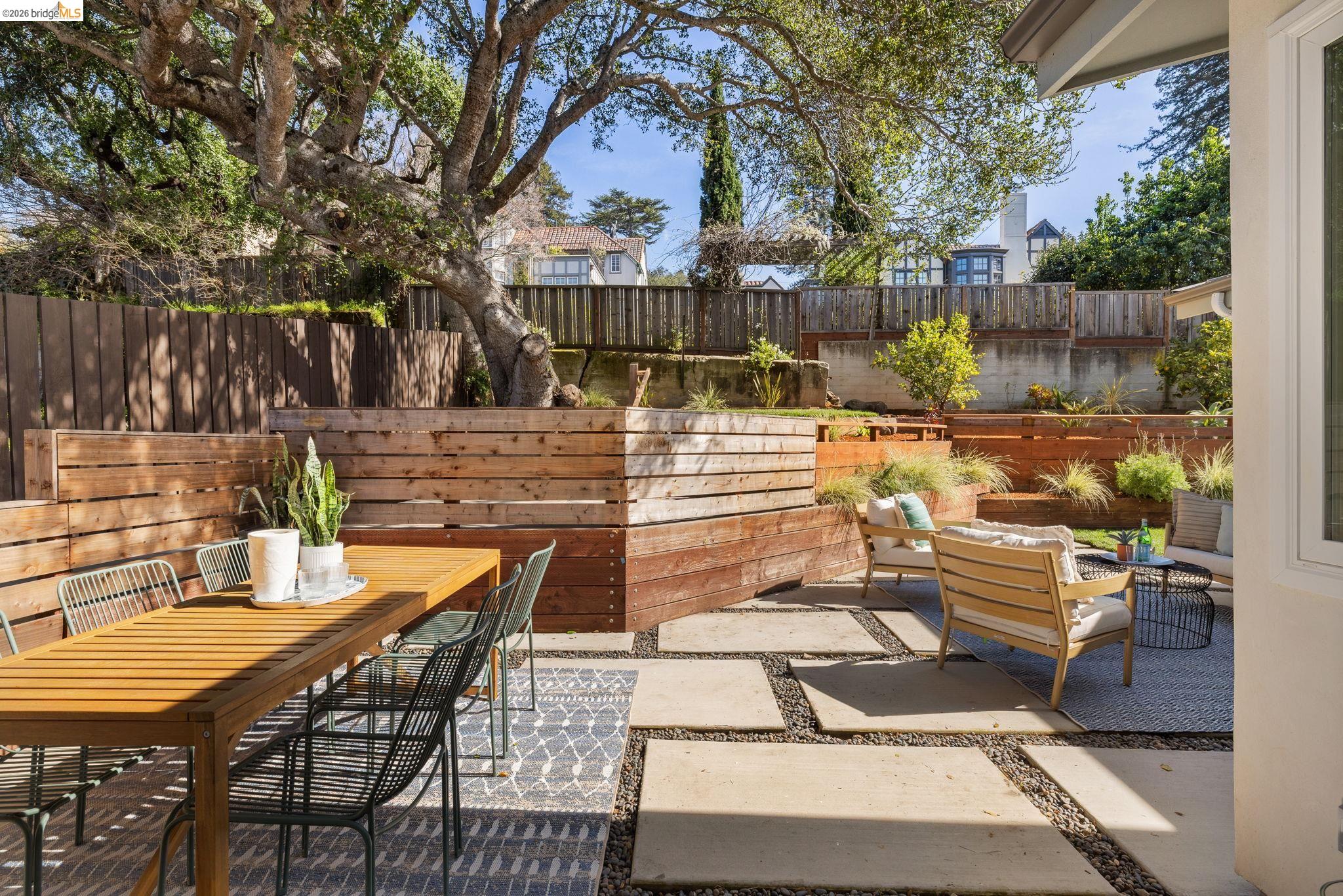 1471 Scenic Avenue Berkeley, CA 94708 - Photo 36 of 42 a view of a patio with couches table and chairs with wooden floor and fence
