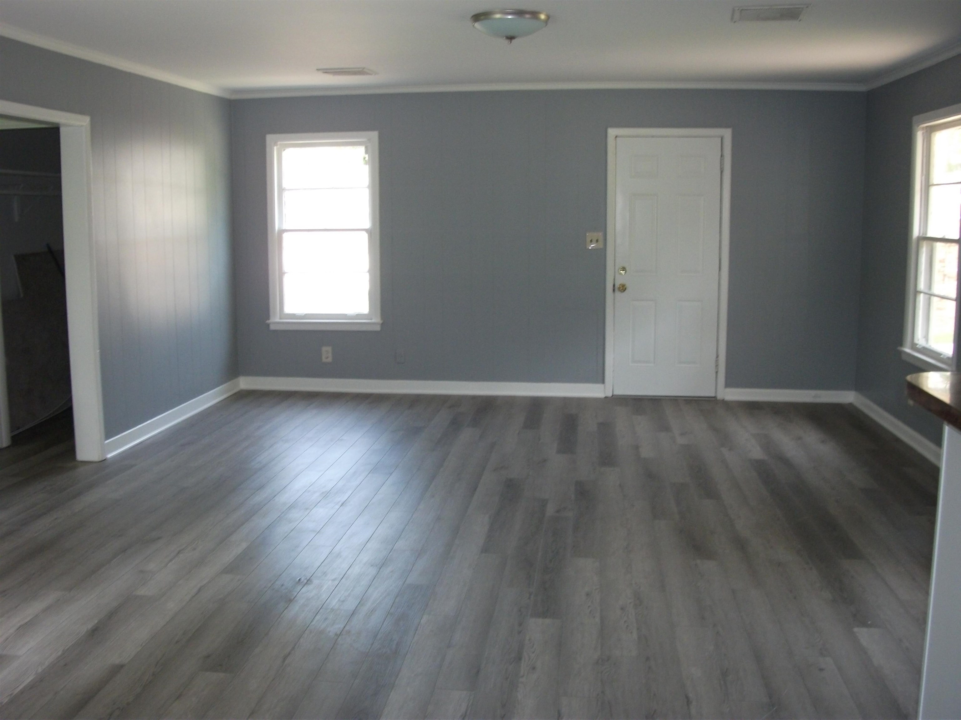 4029 Orleans Road Memphis, TN 38116 - Photo 3 of 11 an empty room with wooden floor and windows