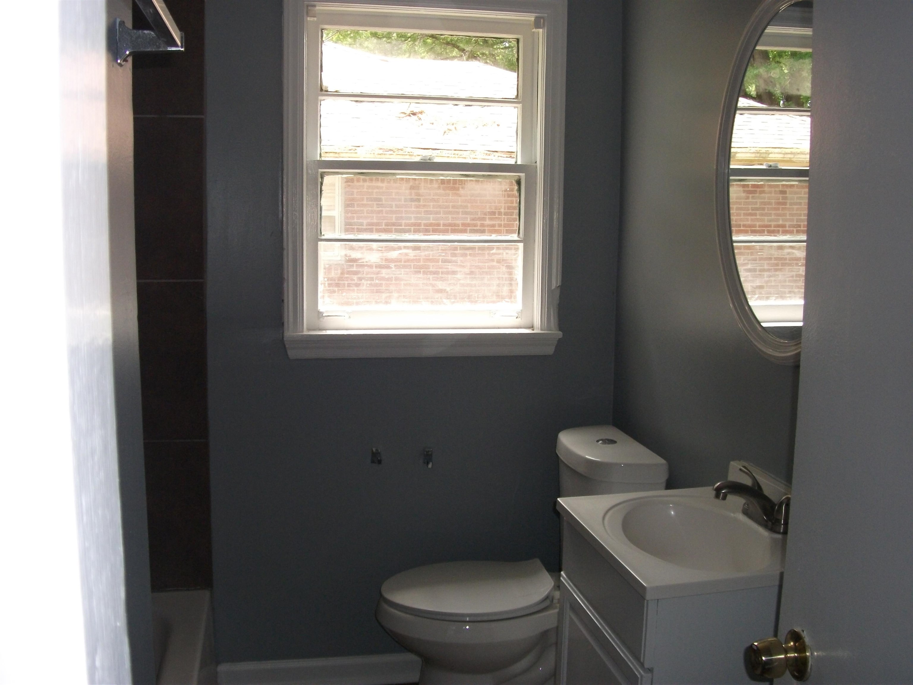 4029 Orleans Road Memphis, TN 38116 - Photo 8 of 11 a bathroom with a toilet a sink and a window