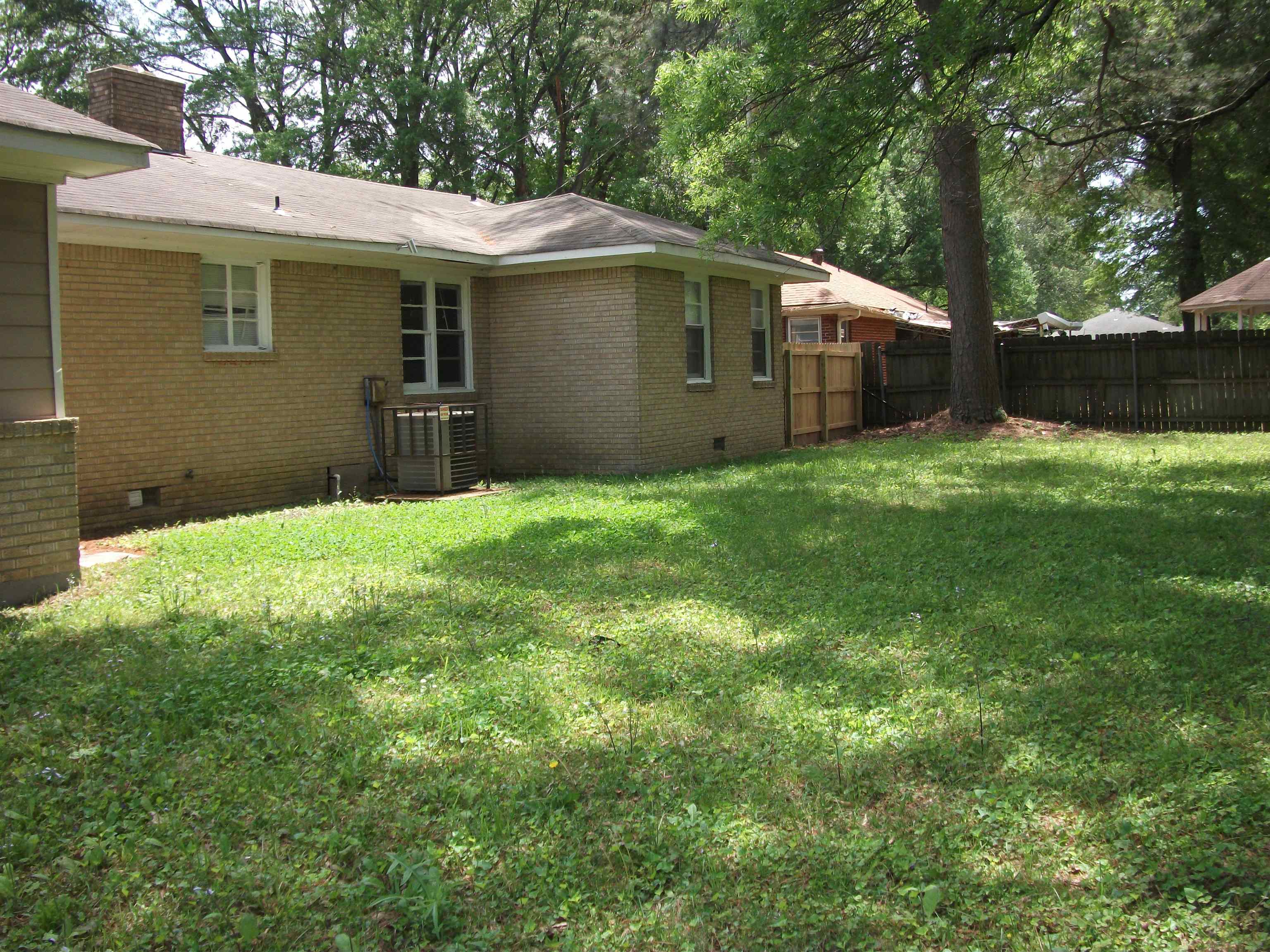 4029 Orleans Road Memphis, TN 38116 - Photo 10 of 11 a backyard of a house with lots of green space