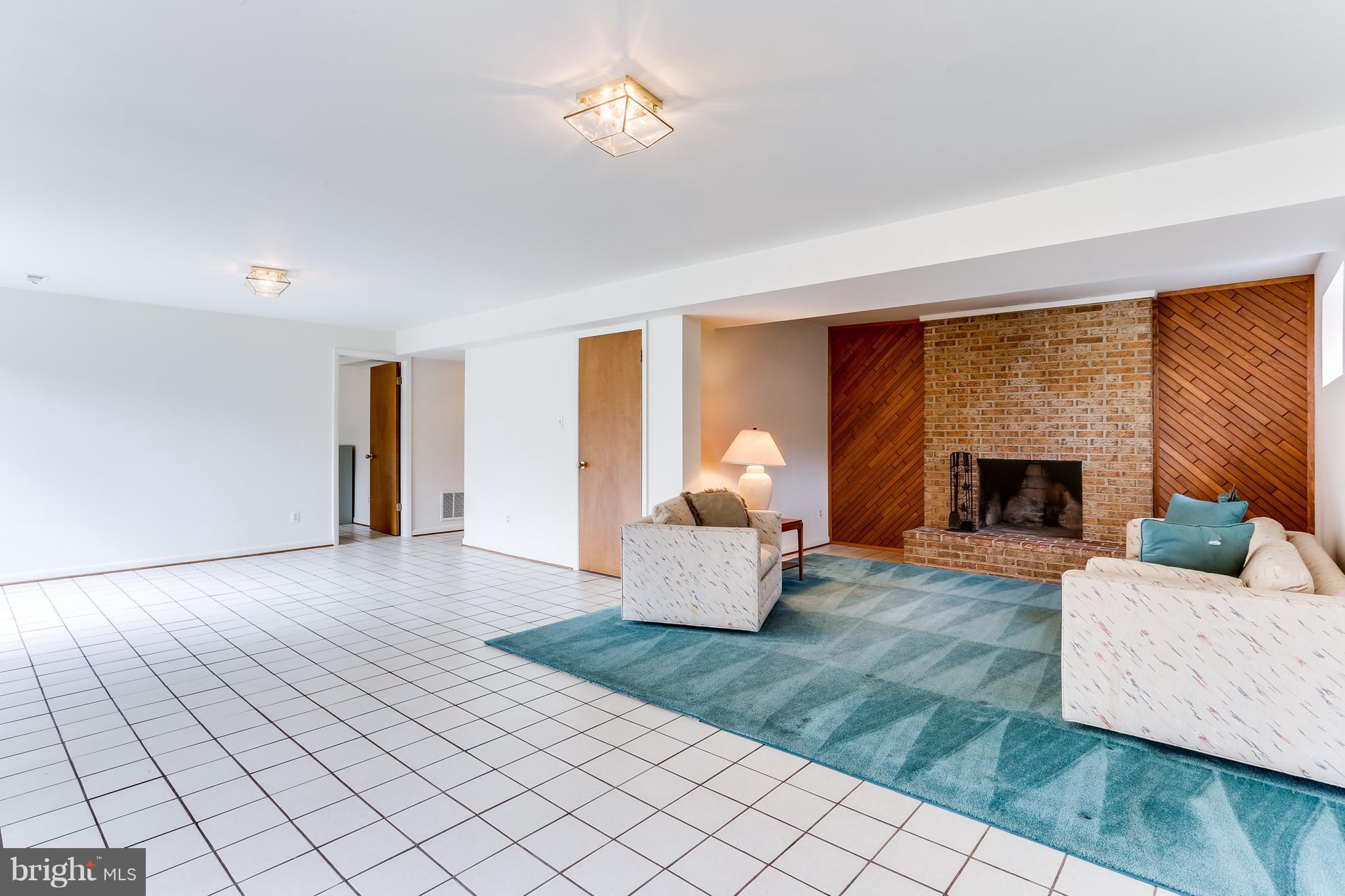1713 Gamewell Road Silver Spring, MD 20905 - Photo 25 of 30 a living room with furniture and a fireplace