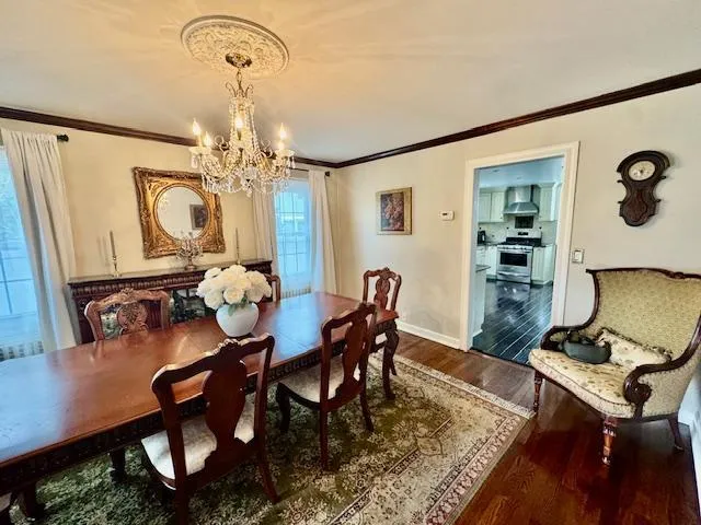 a view of a dining room with furniture and a chandelier