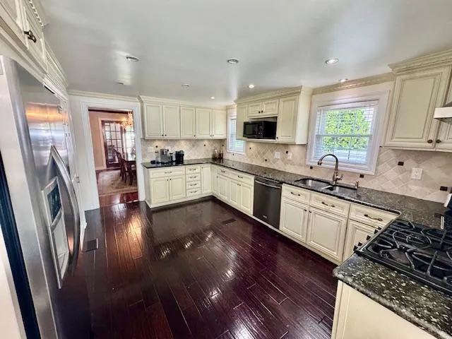 a kitchen with a stove a sink and a refrigerator