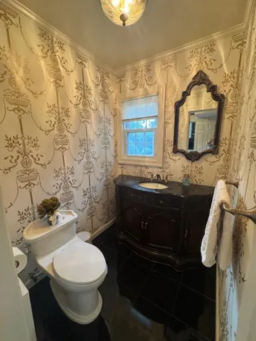 a bathroom with a sink a toilet and shower curtain