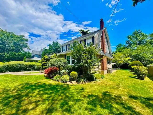 a view of a house with a yard and garden