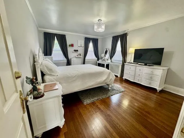 a bedroom with furniture and a flat screen tv