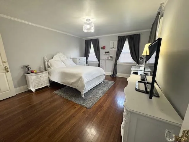 a spacious bedroom with a bed and a window