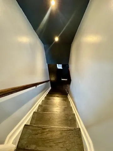 a living room with furniture a flat screen tv and a sink