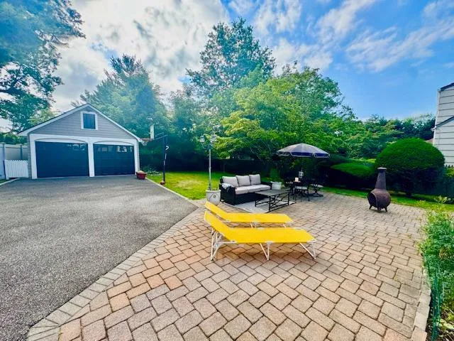 a view of a house with swimming pool and furniture