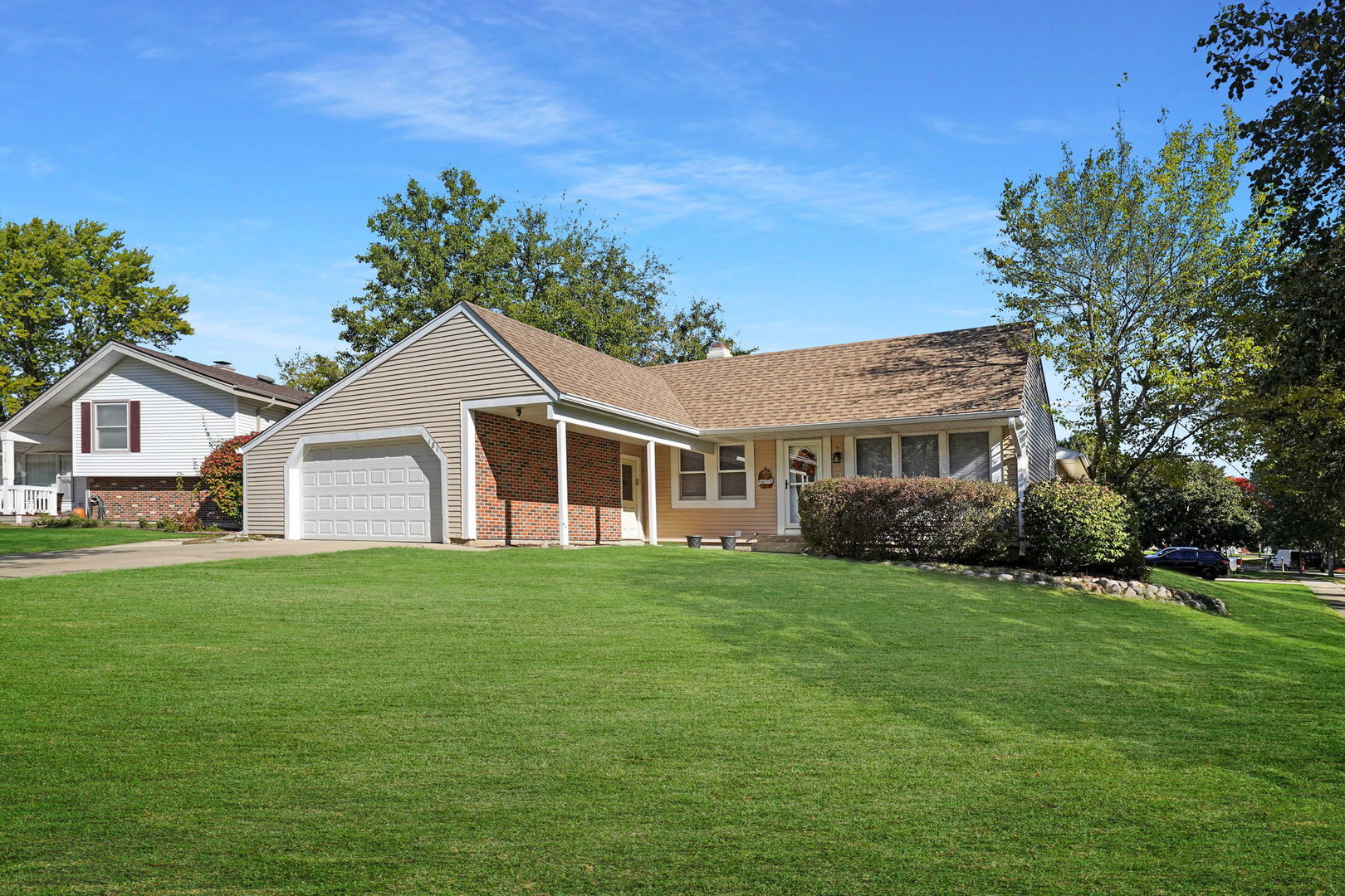 a front view of a house with a garden