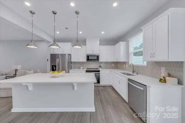 a large kitchen with stainless steel appliances kitchen island a large island in the center