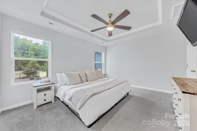 a bedroom with a bed and a large window