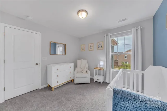 a view of a bedroom with furniture and windows