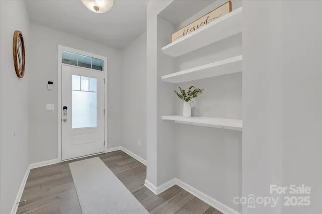 a view of an entryway with wooden floor