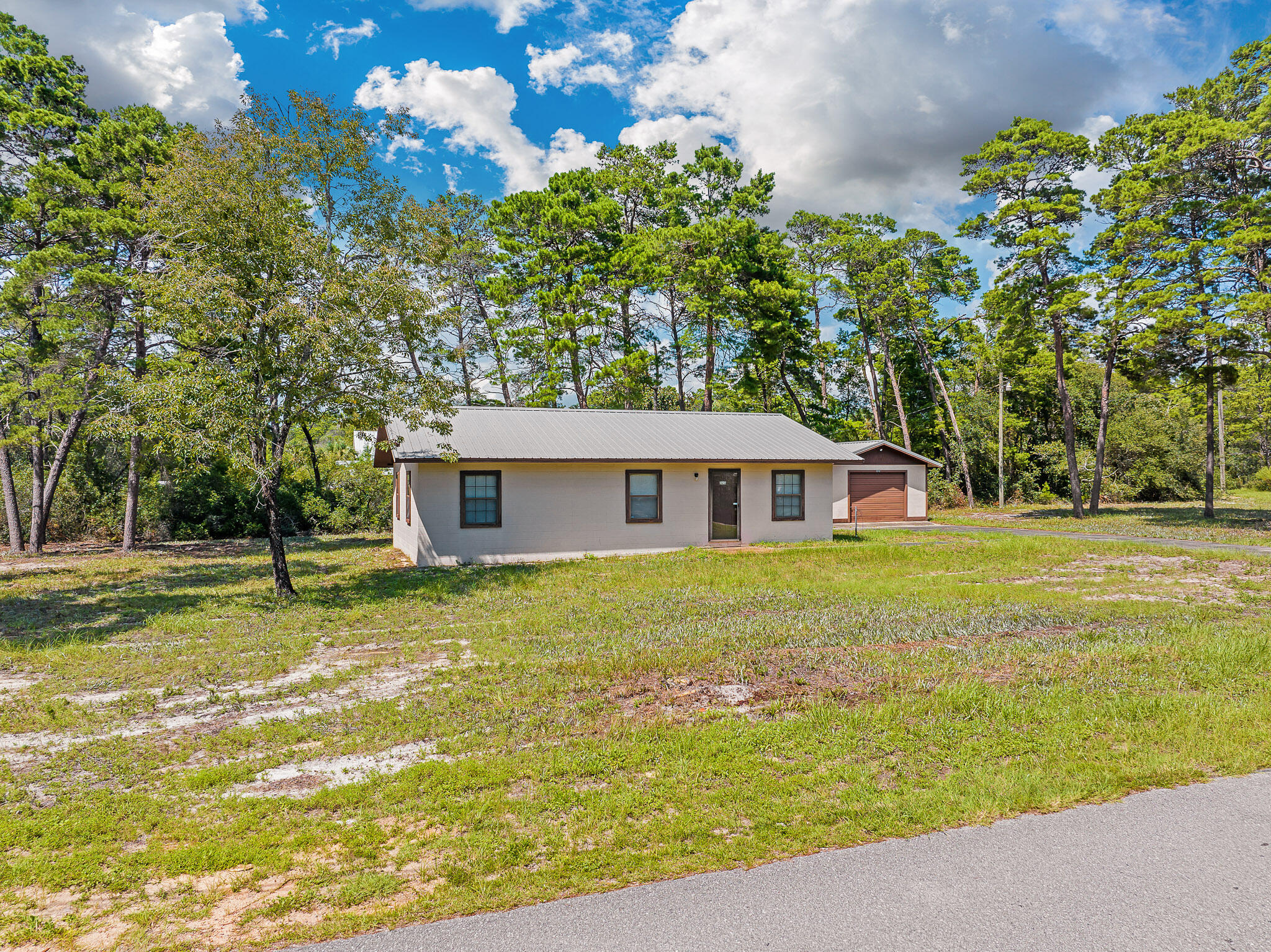 323 Pinewood Lane Inlet Beach, FL 32461 - Photo 15 of 50 a backyard of a house with lots of green space